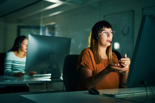 Cropped shot of an attractive young female call center agent working late at night in her office